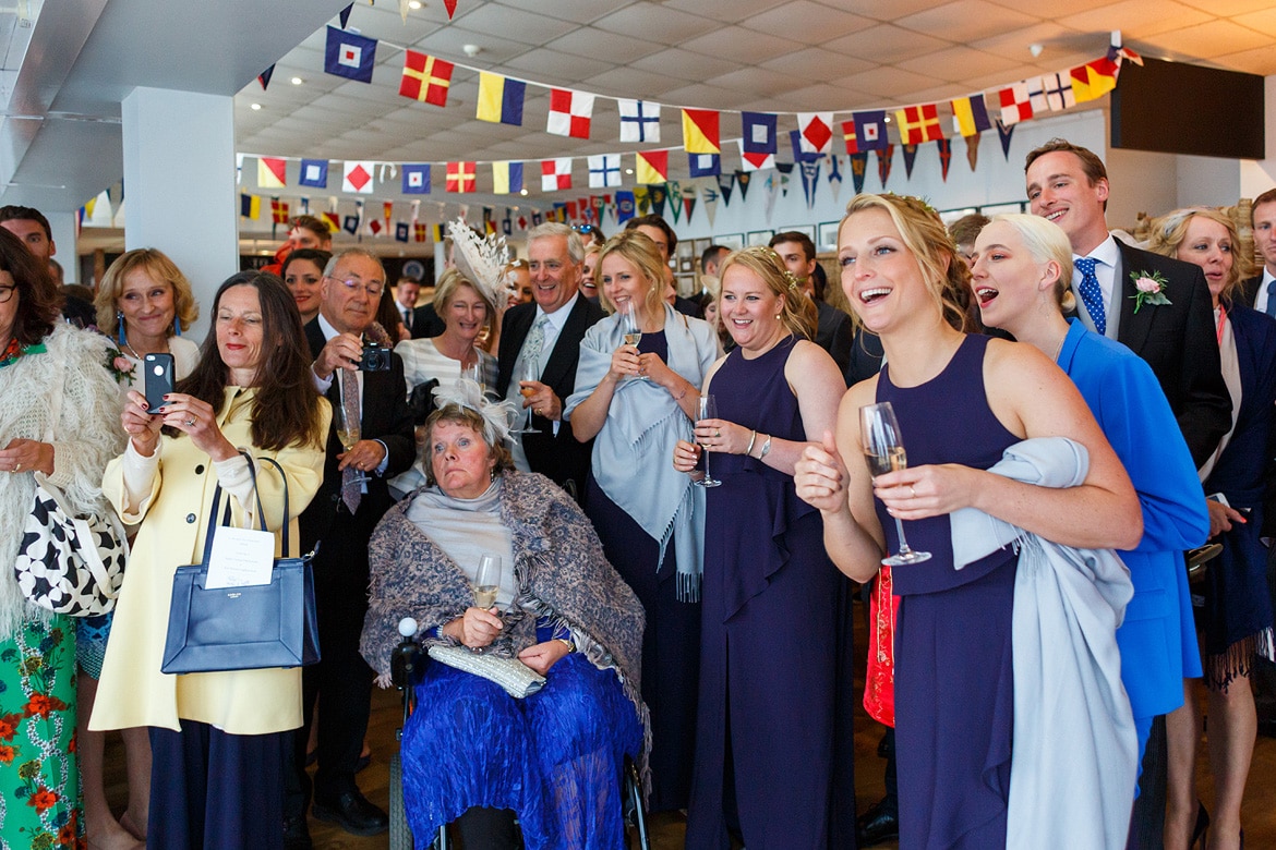 wedding guests watch the cutting of the cake