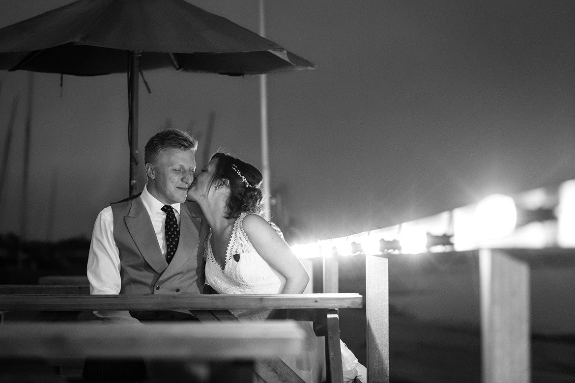 bride and groom kiss outside