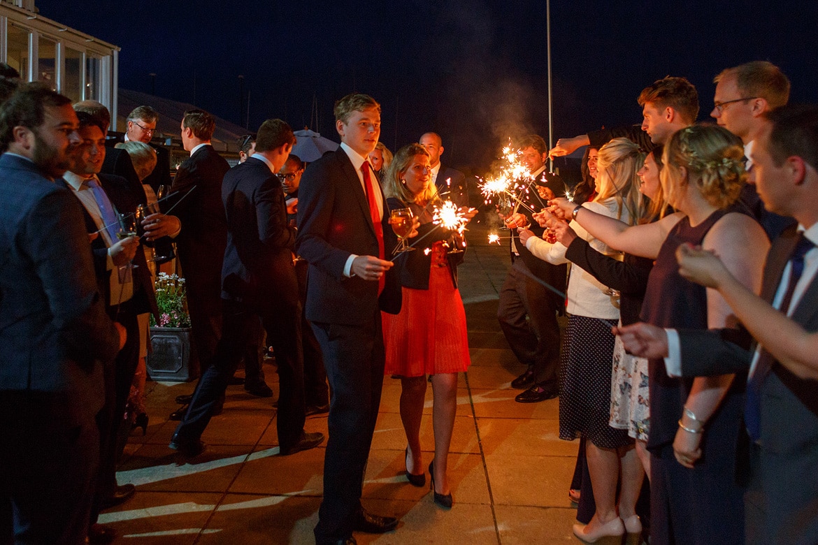 guests light sparklers outside aldeburgh yacht club