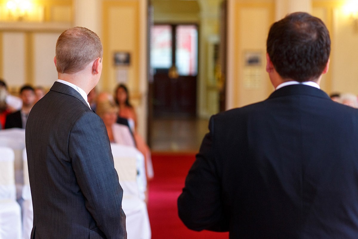 the groom and best man wait for the brides entrance