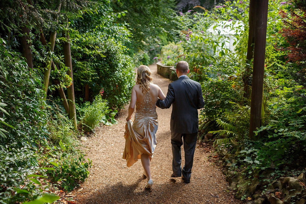 bride and groom walk into the plantation gardens