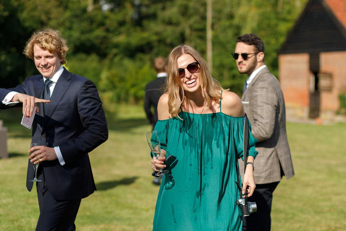 a wedding guests spills champagne on herself