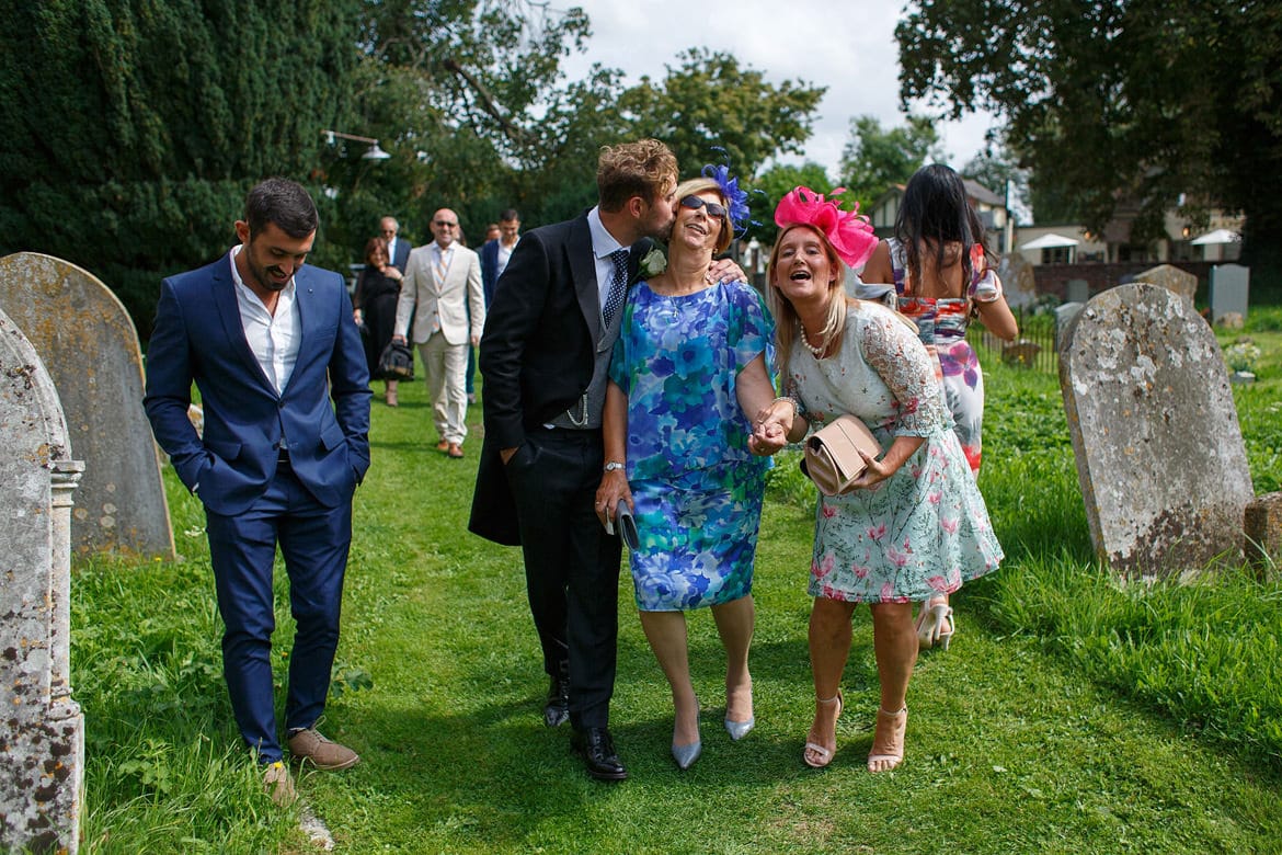 a groom kisses a wedding guest