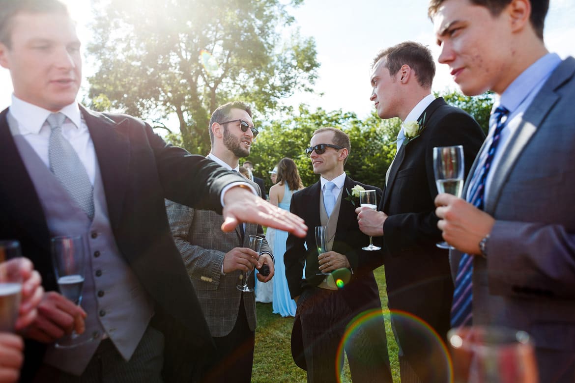 wedding guests talking in the summer sunshine