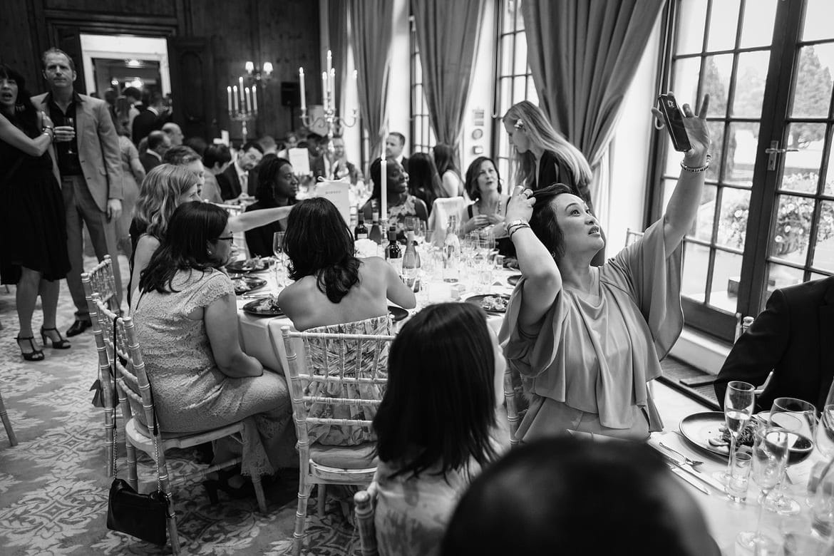 a wedding guest checks her look at hedsor house