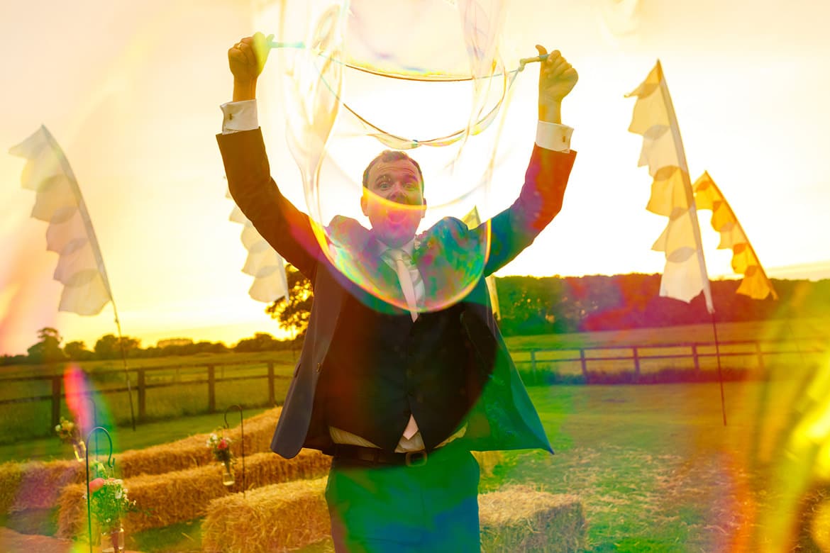 blowing bubbles ata godwick barn wedding