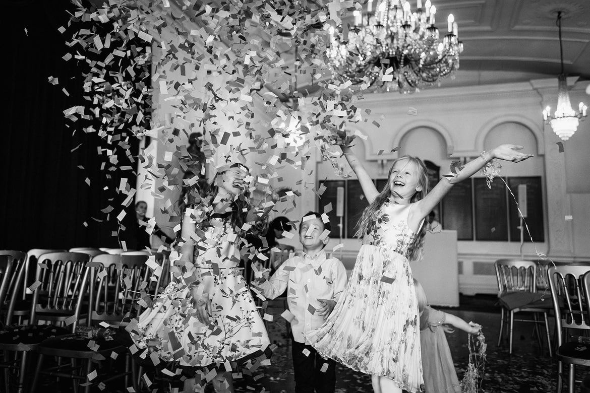 children throw confetti at a trafalgar tavern wedding