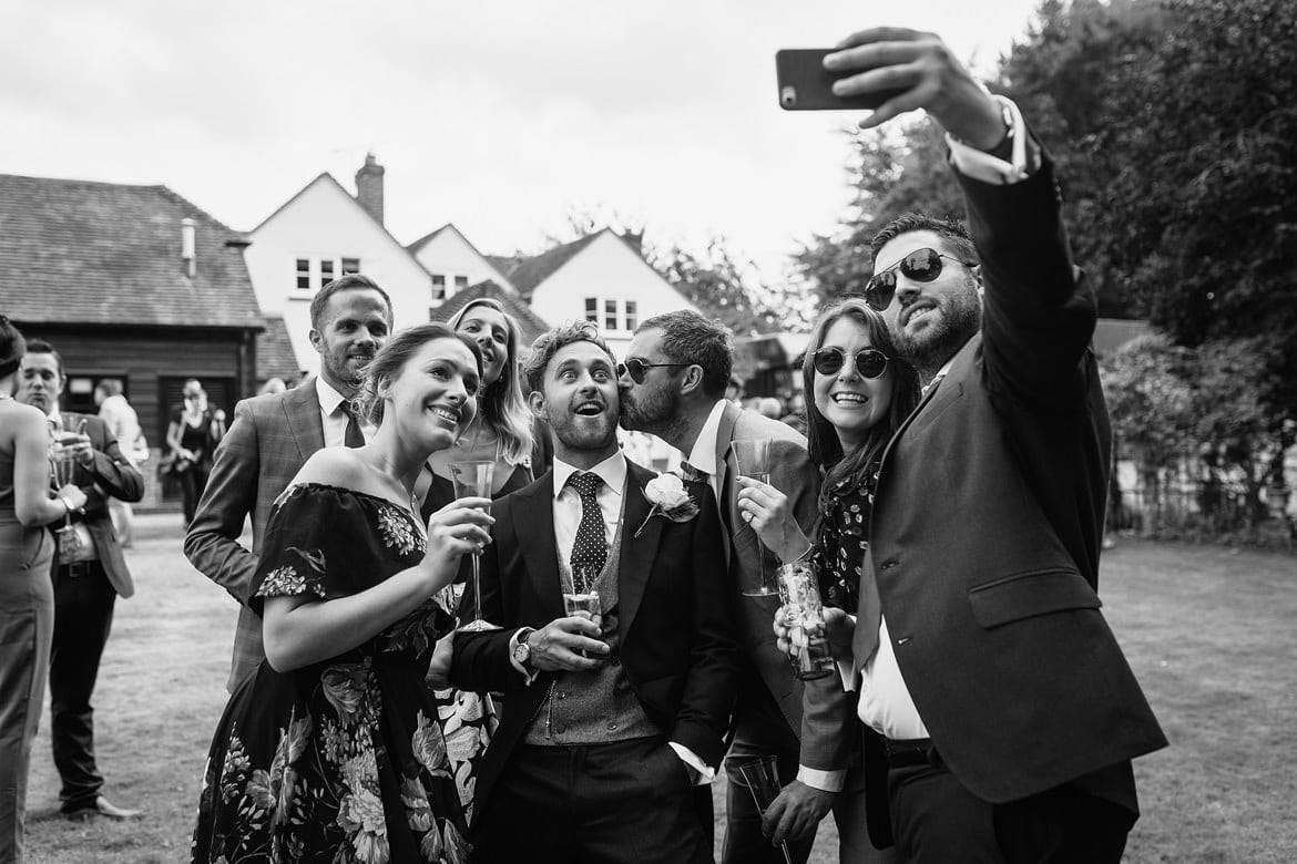 the groom poses with his guests