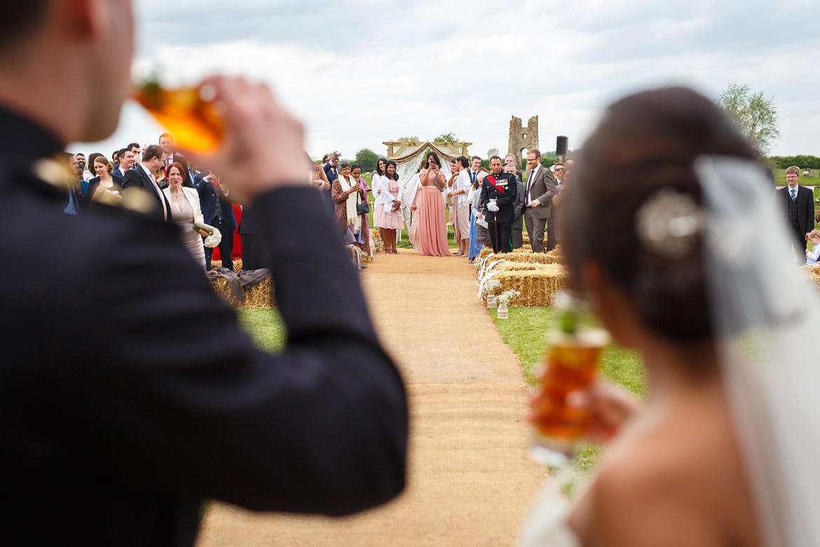 bride and groom look at their wedding guests at godwick hall