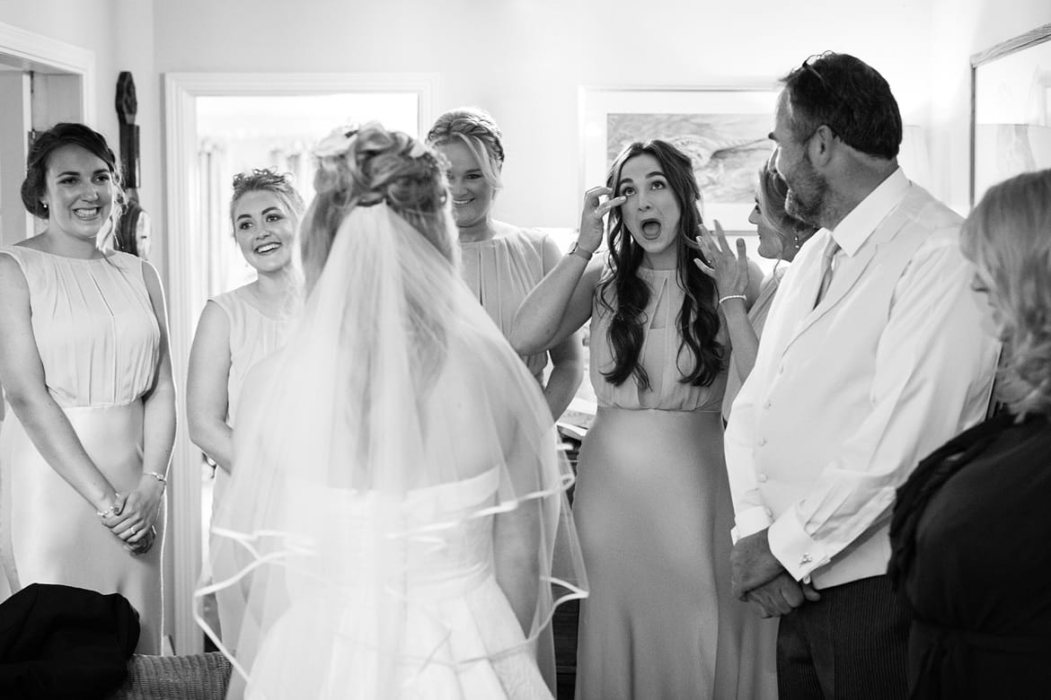 a bridemaid tears up on seeing the bride in her dress