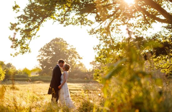 bride and groom in the fields at pennard house