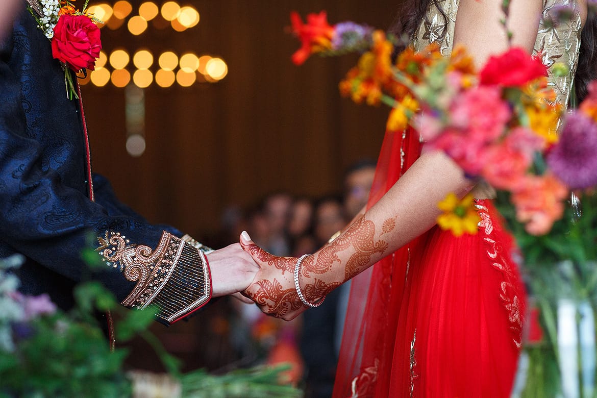 holding hands at a sussex barn wedding ceremony