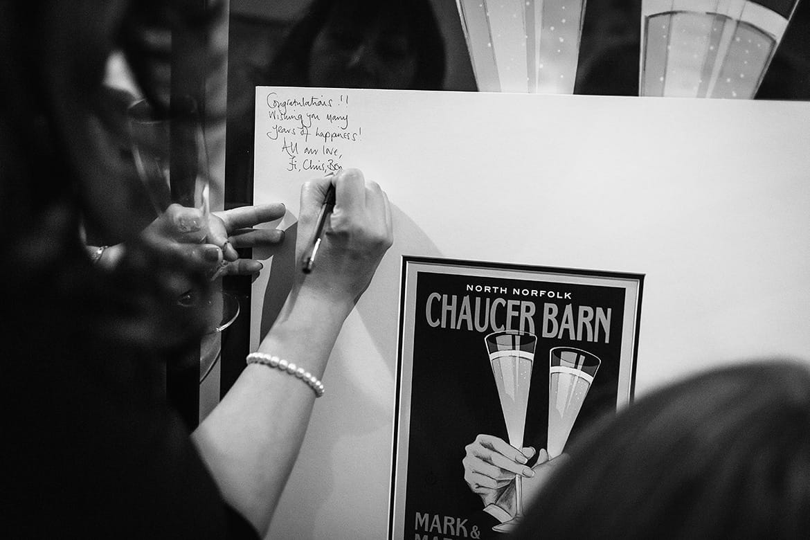 a guest signs the picture frame at chaucer barn