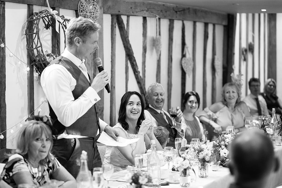 the bride laughs at the grooms speech