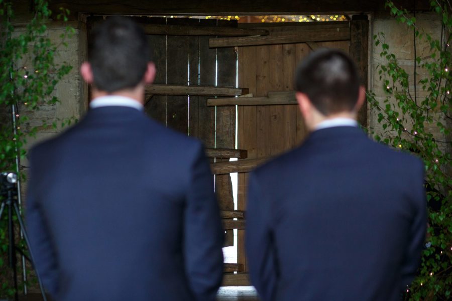 groom and best man waiting for the bride at cripps stone barn