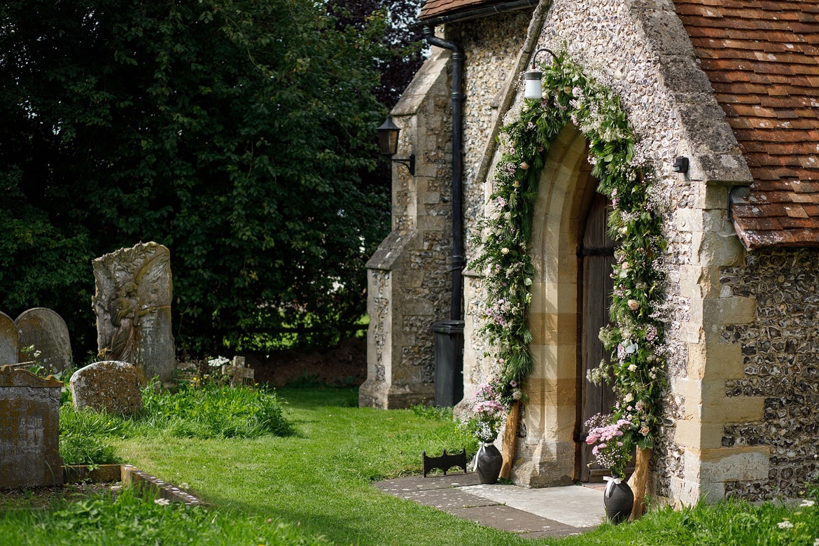 a flower arch around a church doorway