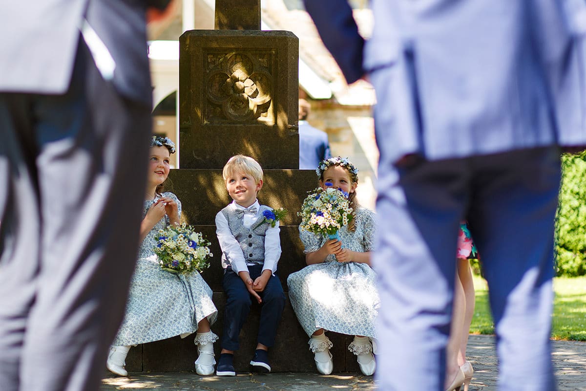 page boys and flower girls outside the church