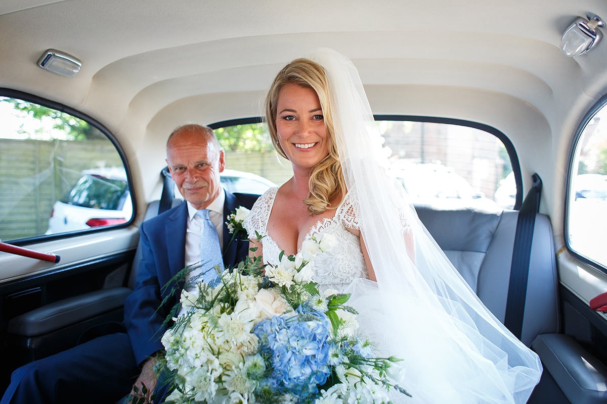 the bride with her father in the taxi