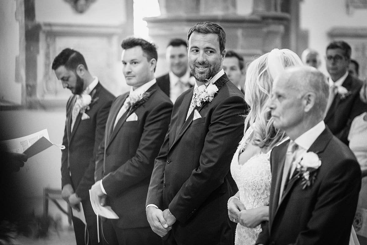 todd smiles at laura as she reaches the end of the aisle