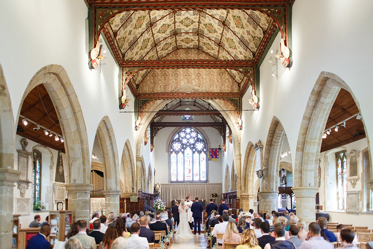 wide shot of a wedding in holy trinity church cuckfield