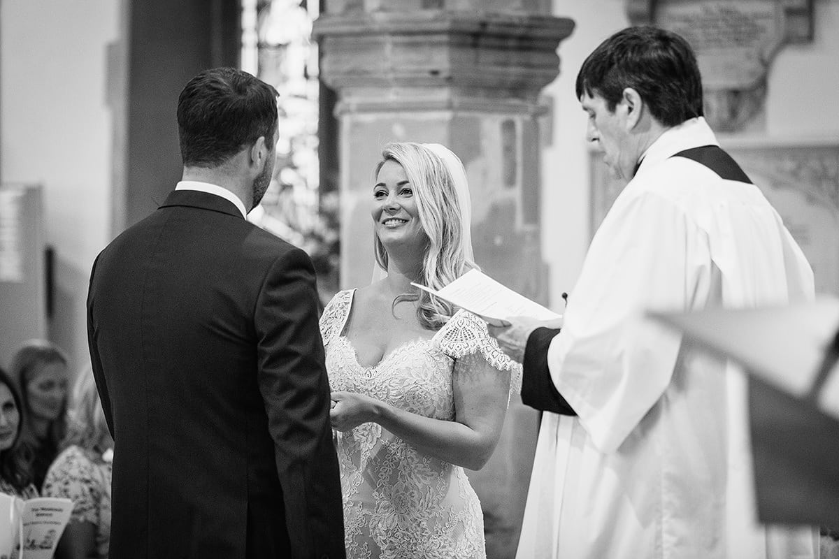 the bride gives the groom his ring