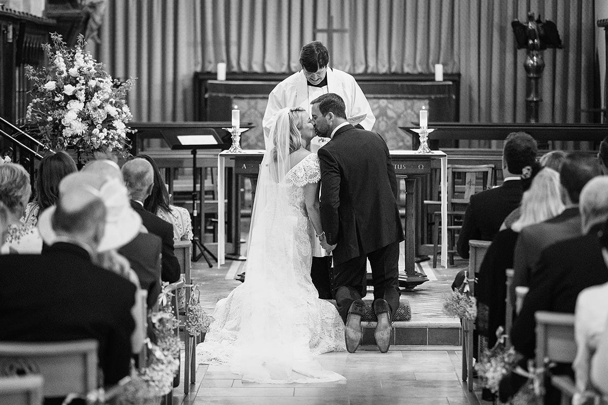 laura and todd kiss in cuckfield church