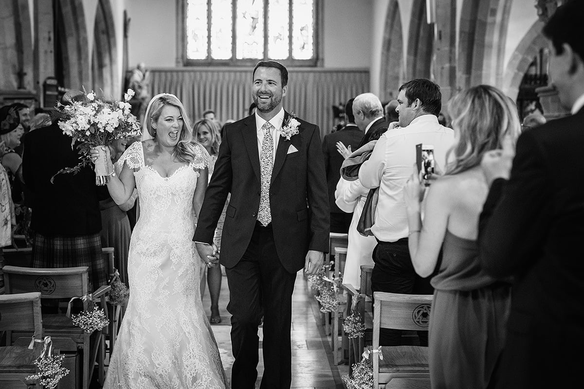 laura and todd walk down the aisle after their wedding ceremony