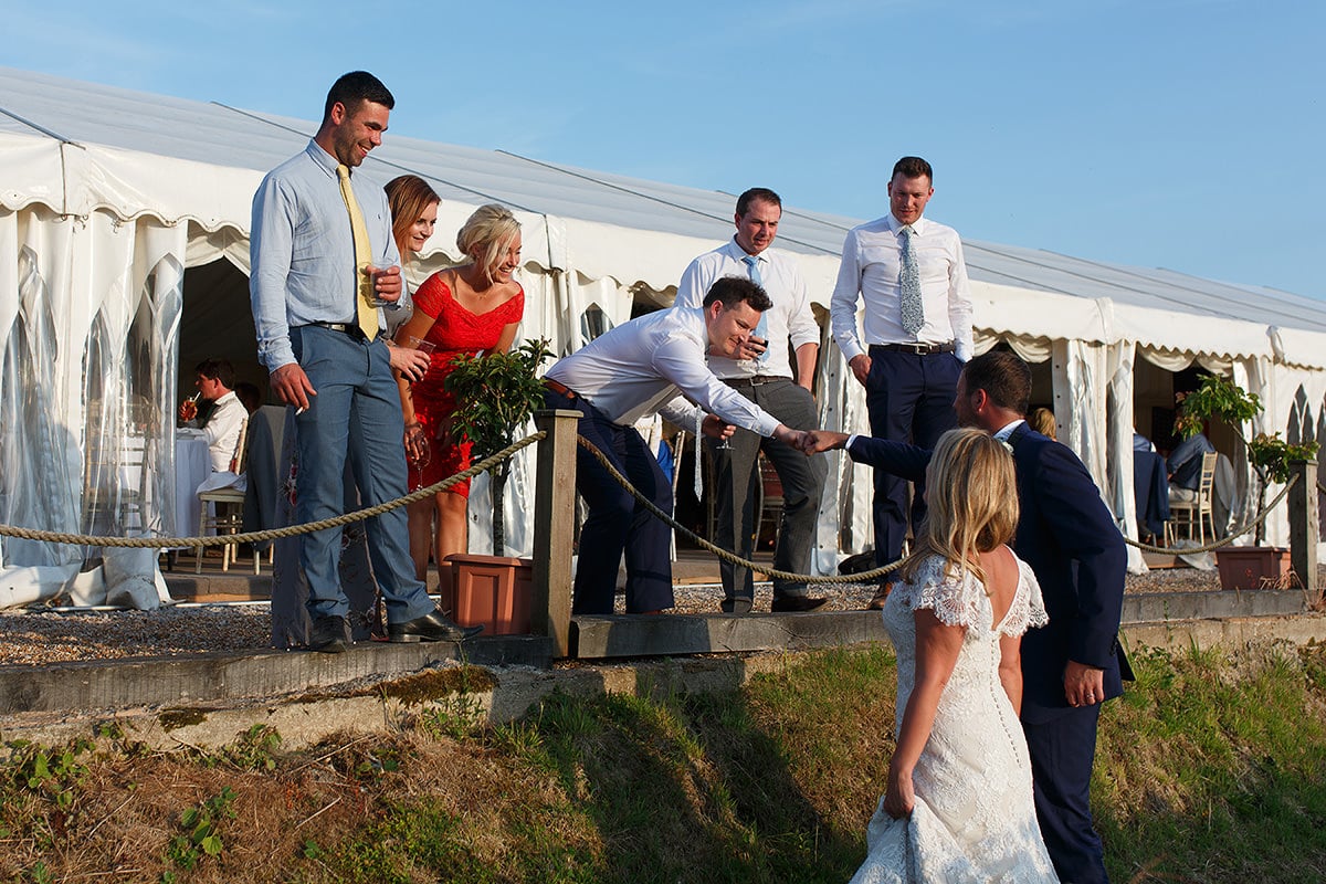 the groom fist bumps a guest