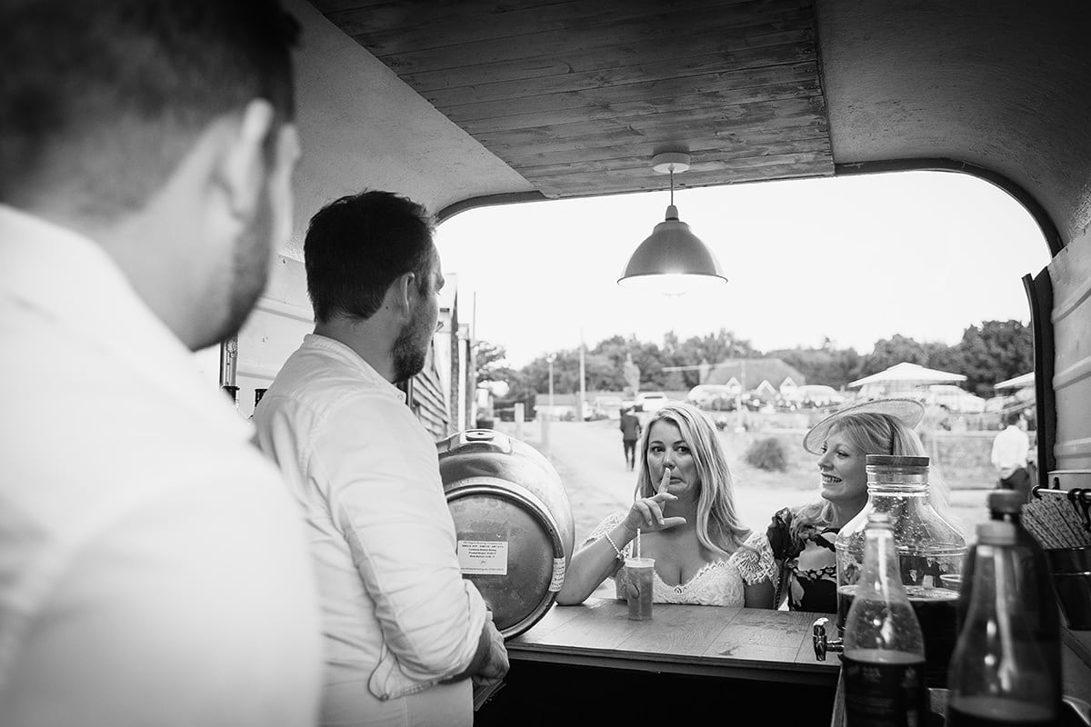 laura grabs a drink from the horsebox bar