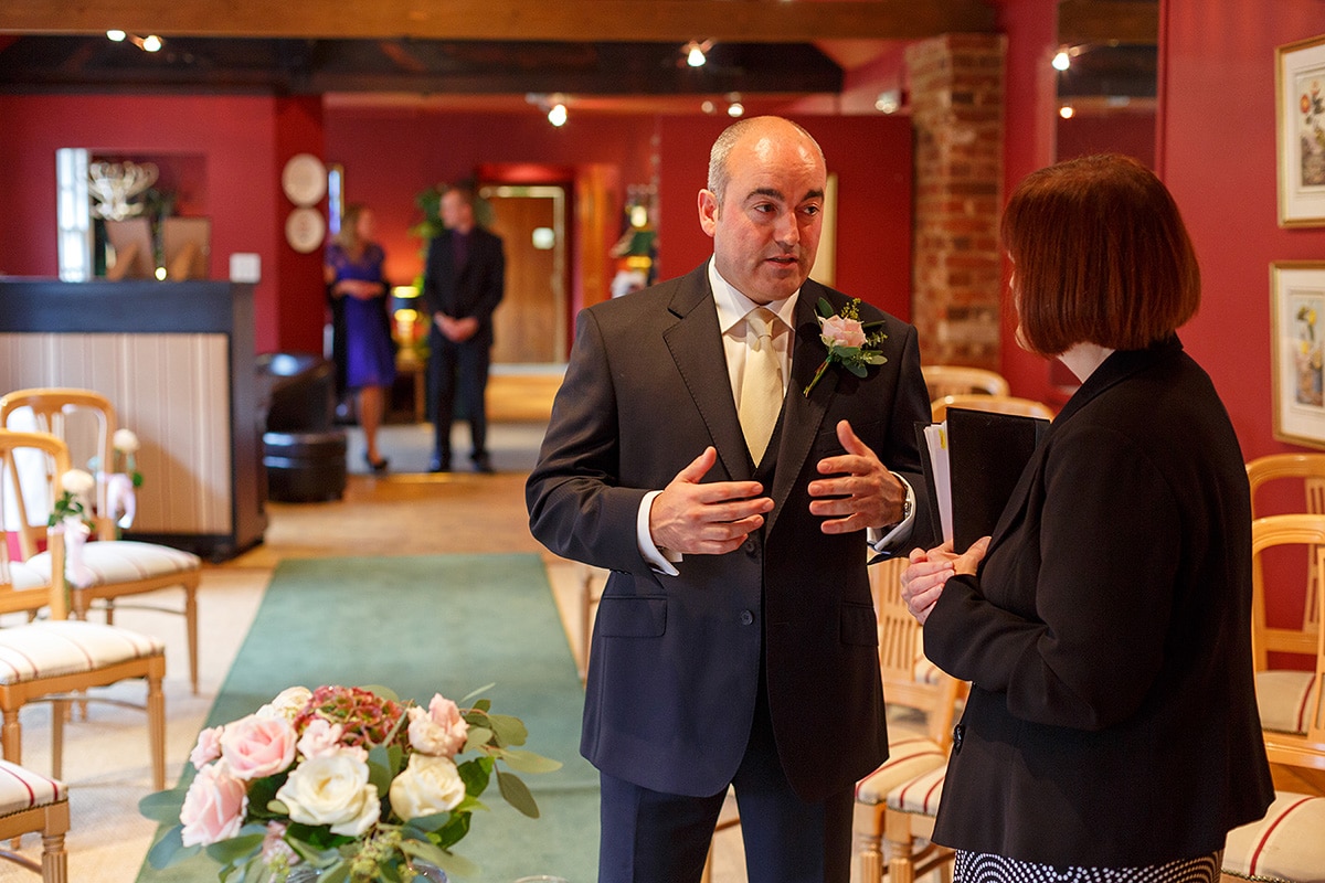 the groom talks with the registrar at brasteds