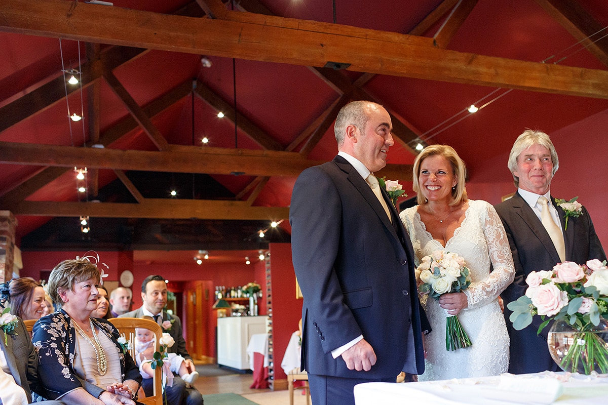 a happy bride and groom in brasteds ceremony room