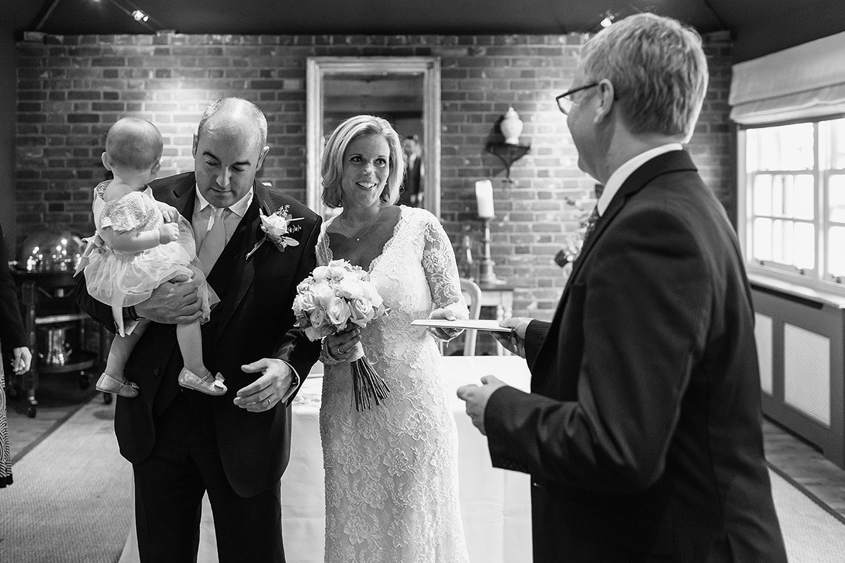 the registrar hands the couple their wedding certificate