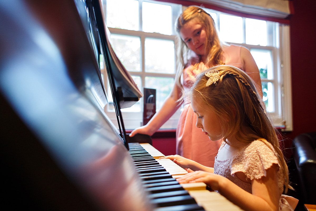 the flower girls play on the piano