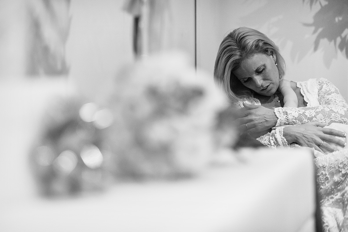 the bride breastfeeds her baby daughter