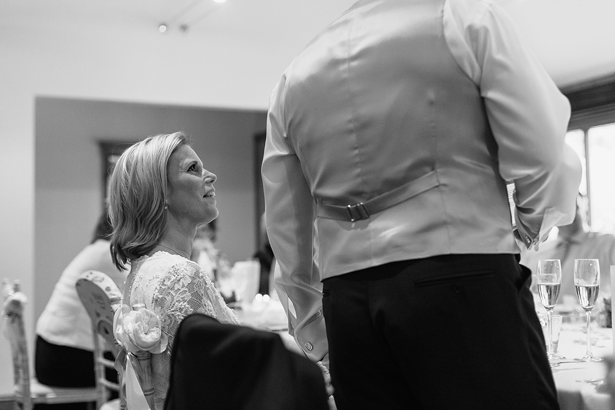 the bride listens to the grooms speech