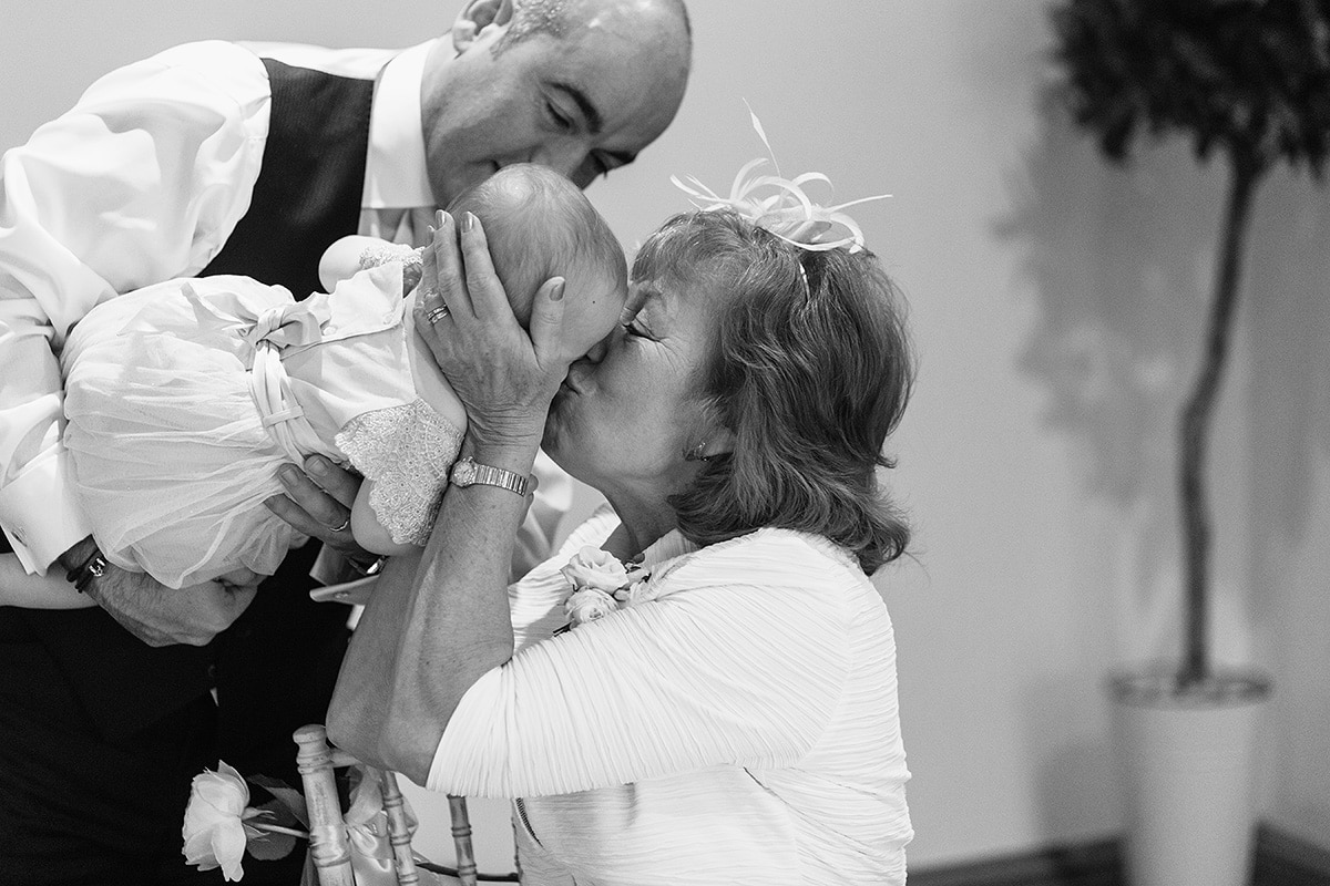 a guest kisses the couples new baby