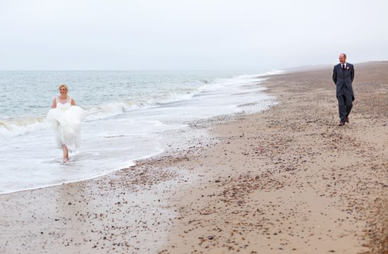 bride and groom on cley beach in north norfolk