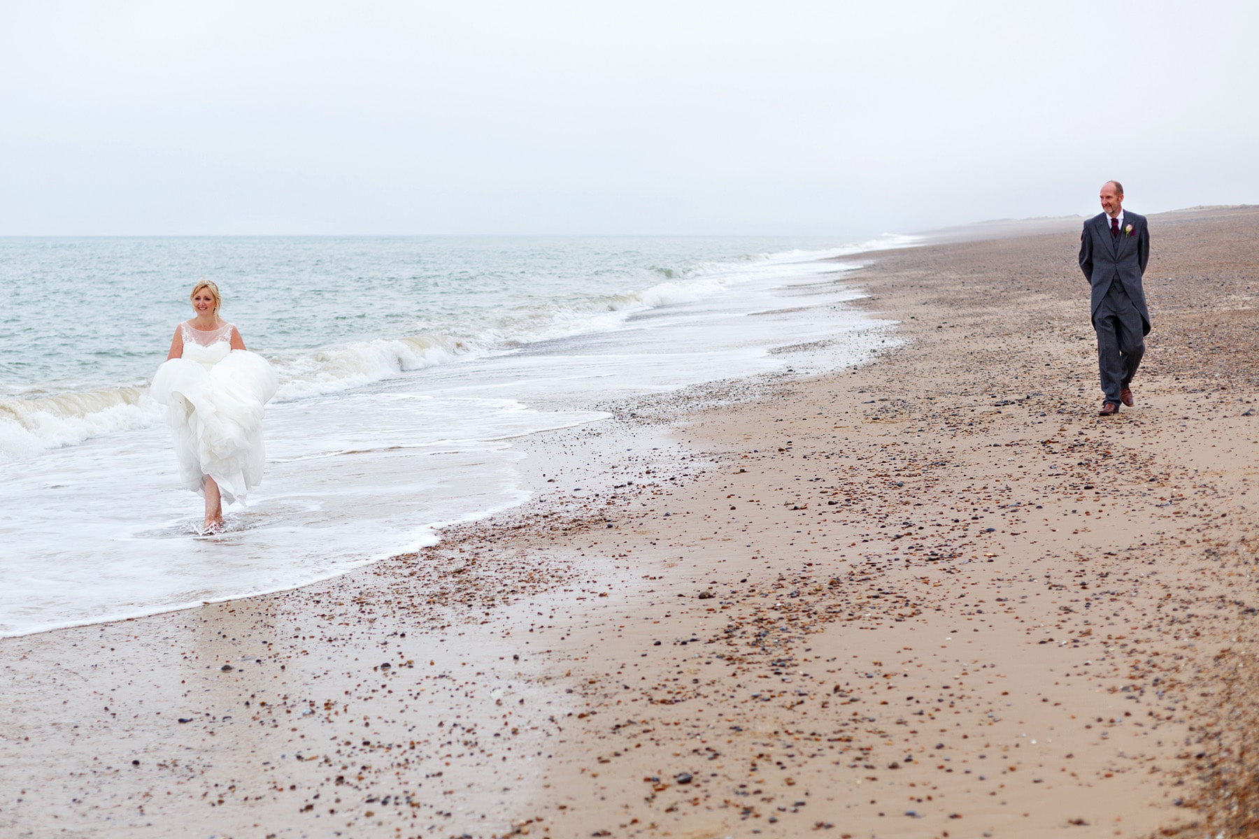 bride and groom on cley beach in north norfolk