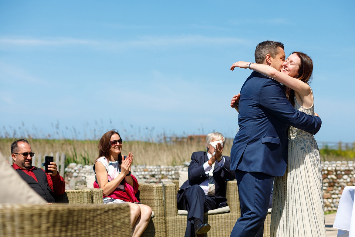 hugs at their outdoor wedding