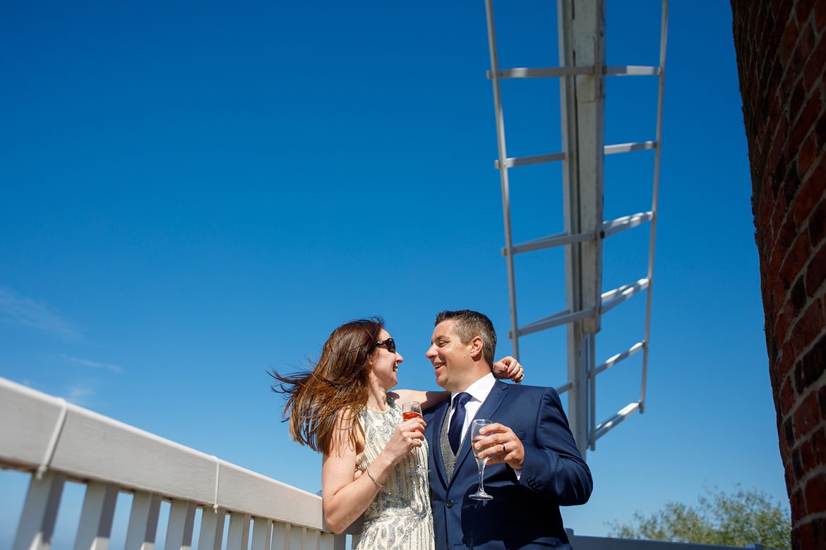 the happy couple on the balcony of cley mill