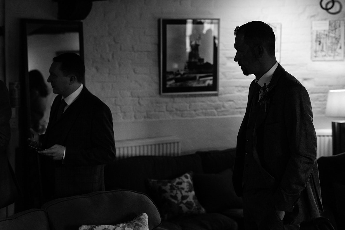 the groom waits in the ceremony room at cley windmill