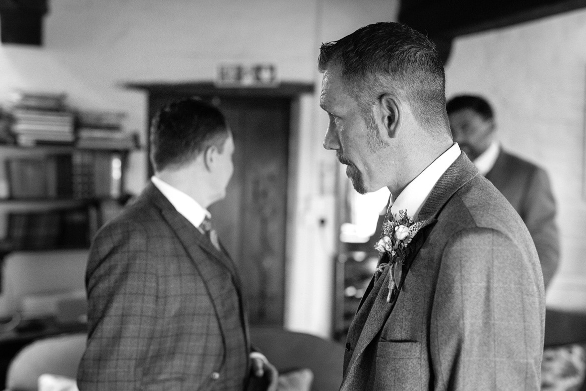 simon waits for alice at their cley mill wedding