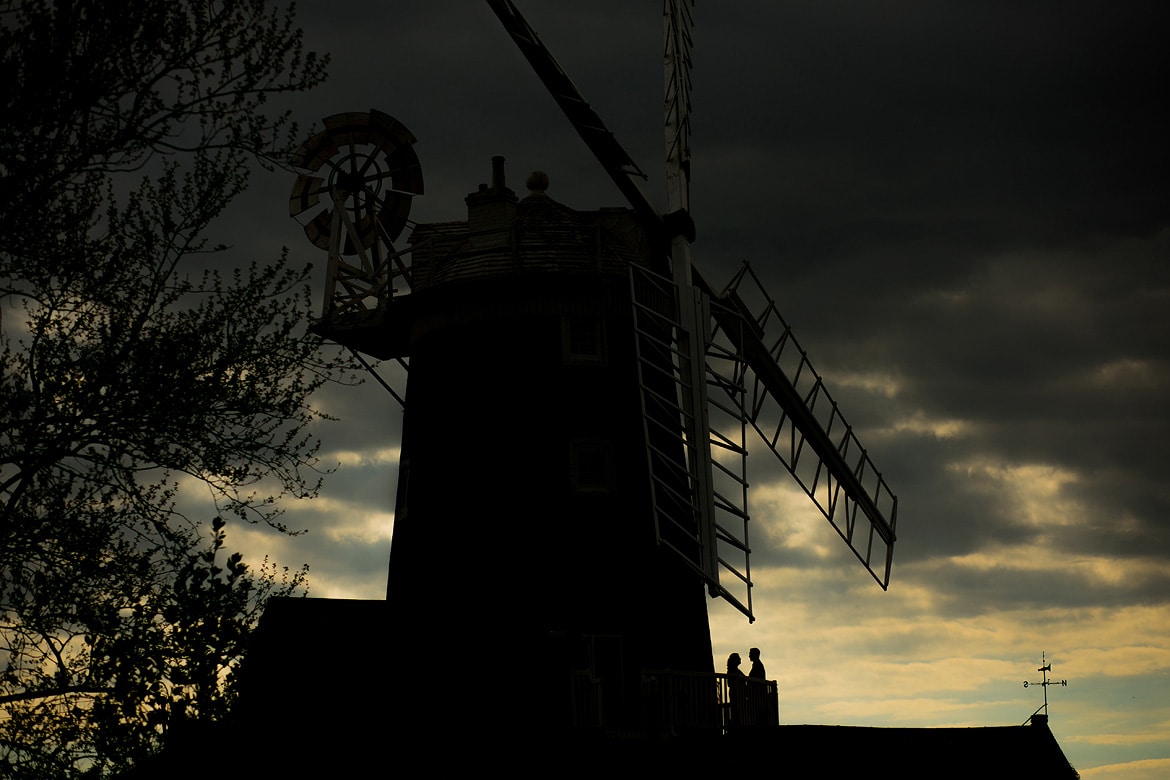 a silhouette on the balcony at a cley mill wedding