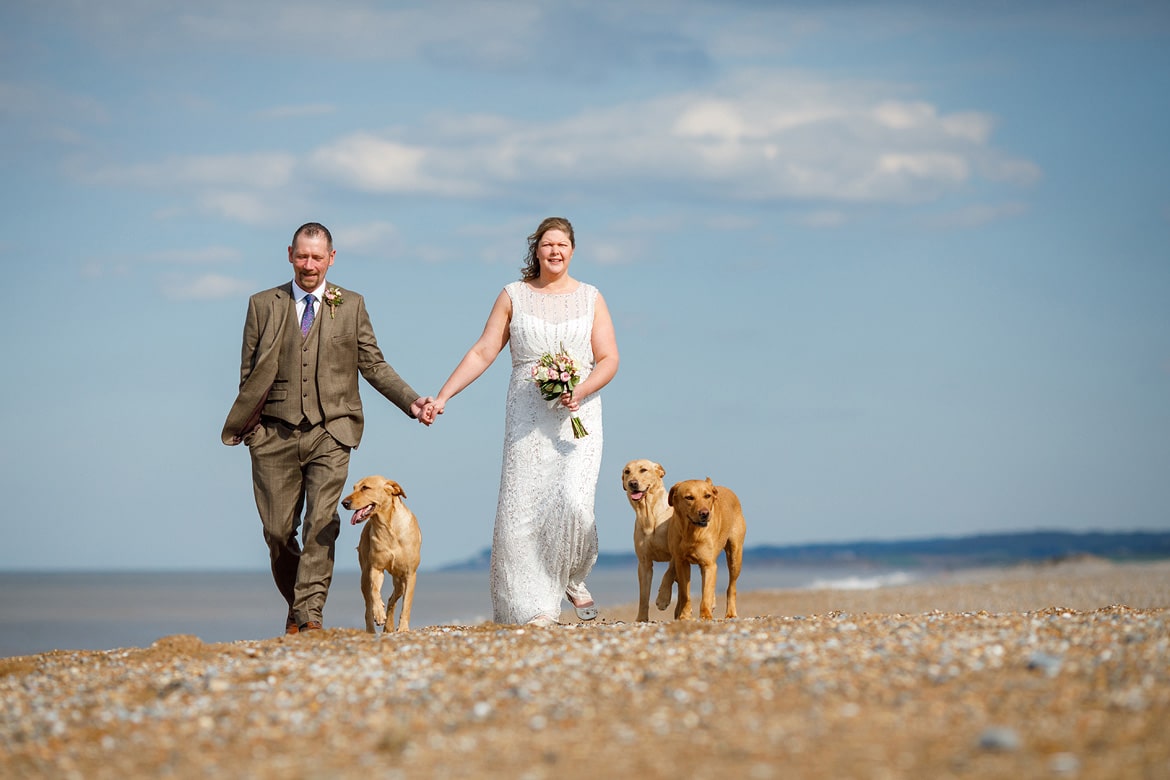 bride and groom on the beach at cley next the sea