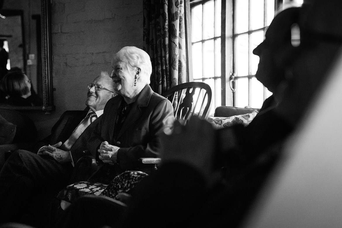 guests look on at a cley windmill wedding