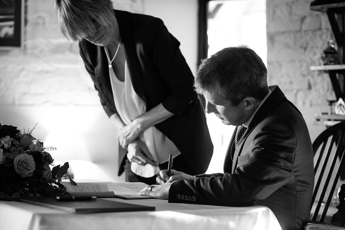 the groom signs the register