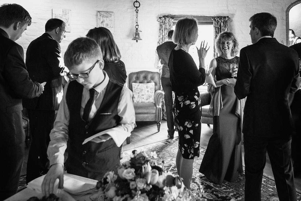 the bride laughs with guests at a cley windmill wedding