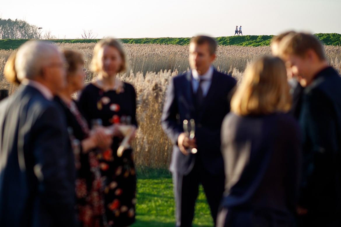 drinks outside with walkers on the norfolk coastal path in the background