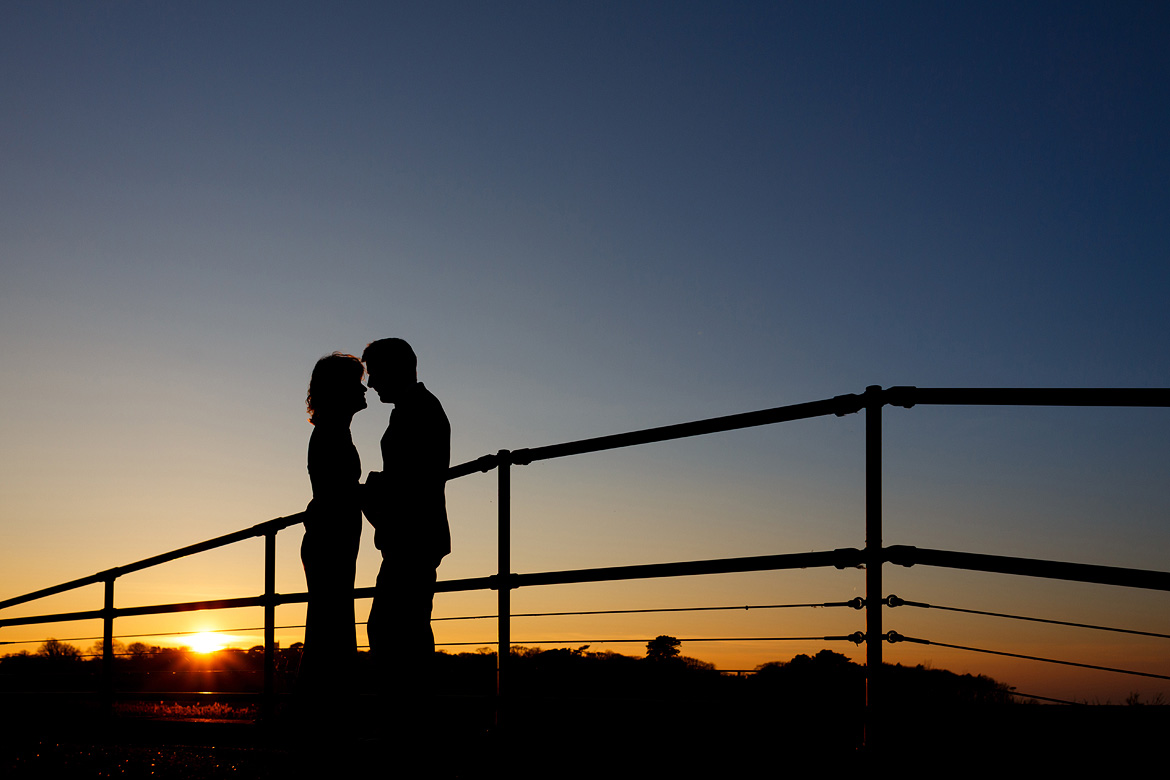 a sunset wedding silhouette on the bridge at cley windmill