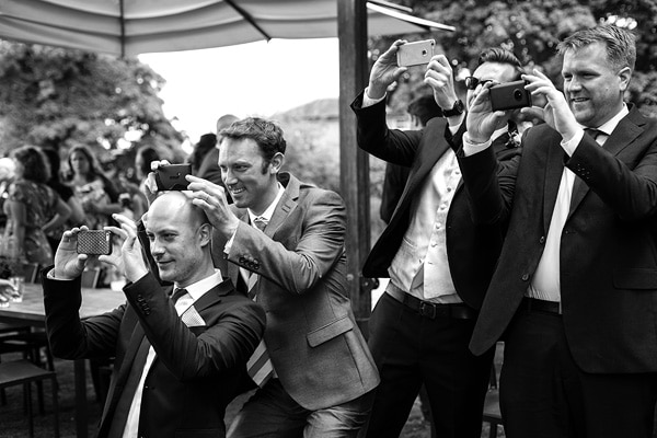 wedding guests taking photos on their mobile phones